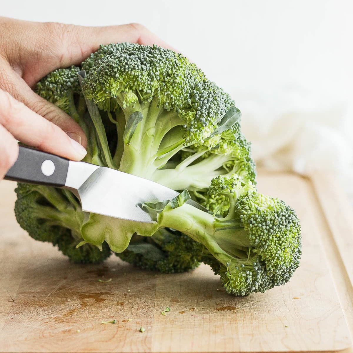 Cutting broccoli into chunks.