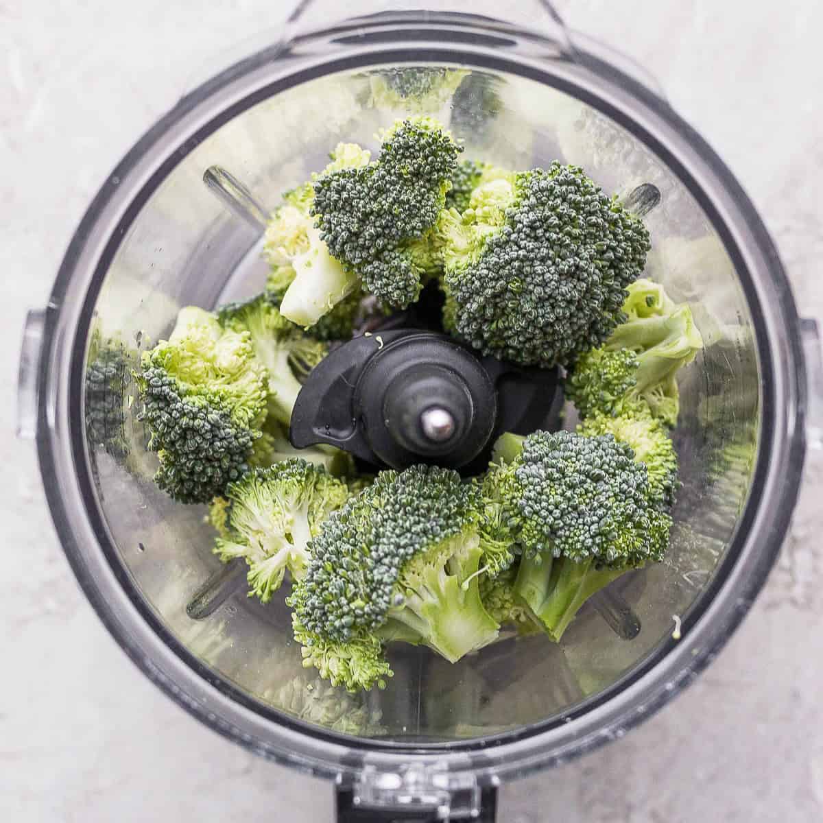 Broccoli florets in food processor before processing.