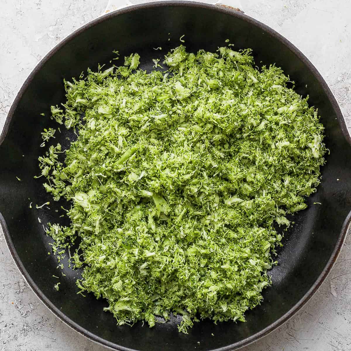 Pan with grated broccoli before cooking.