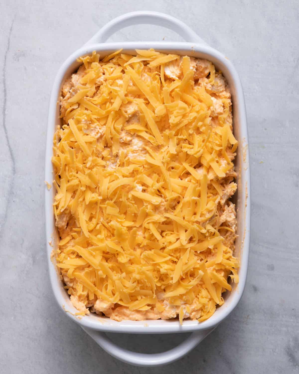 Mixture transferred to baking dish with remainder cheese added on top.