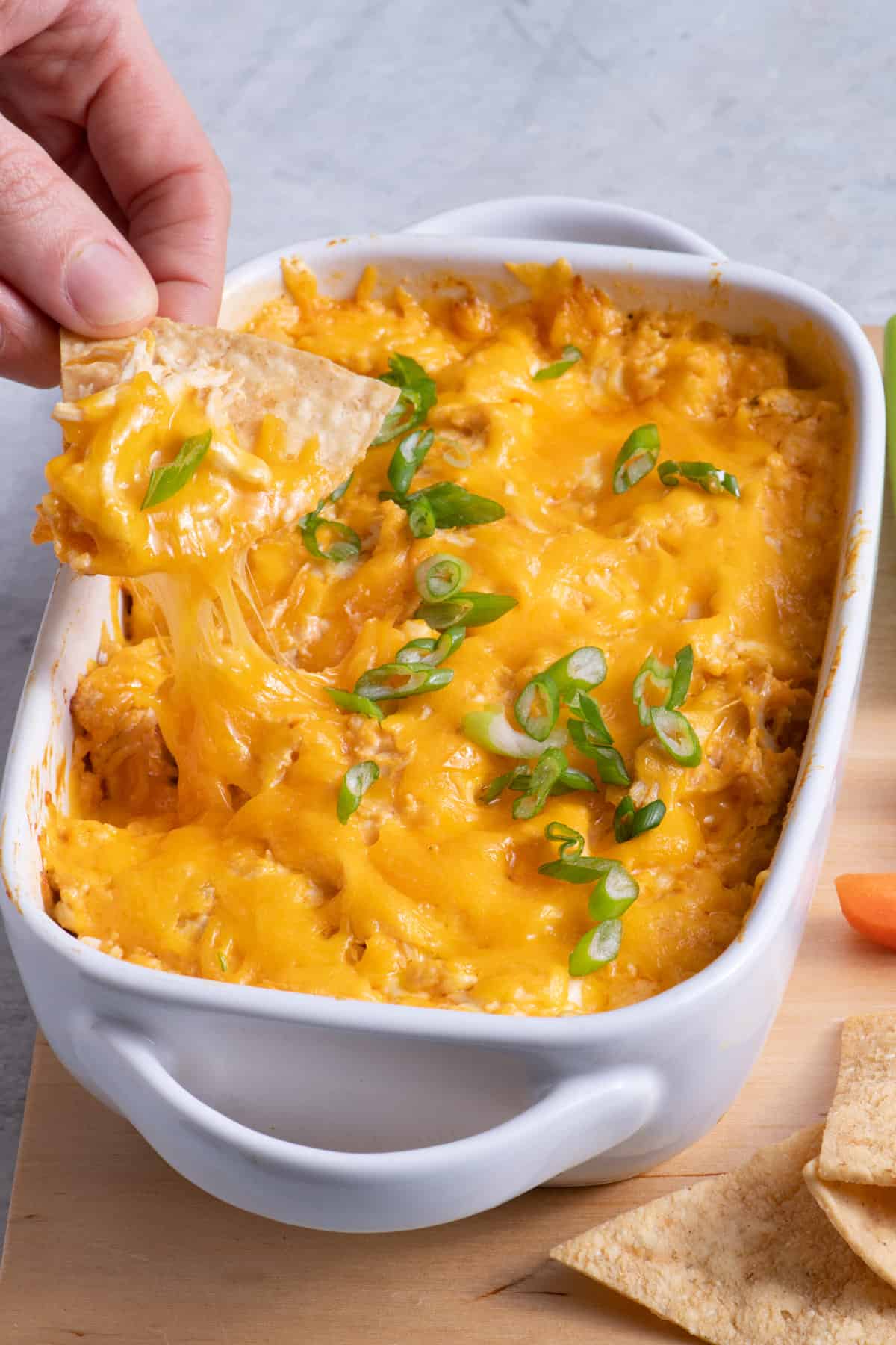 Chip dipping into healthy buffalo chicken dip