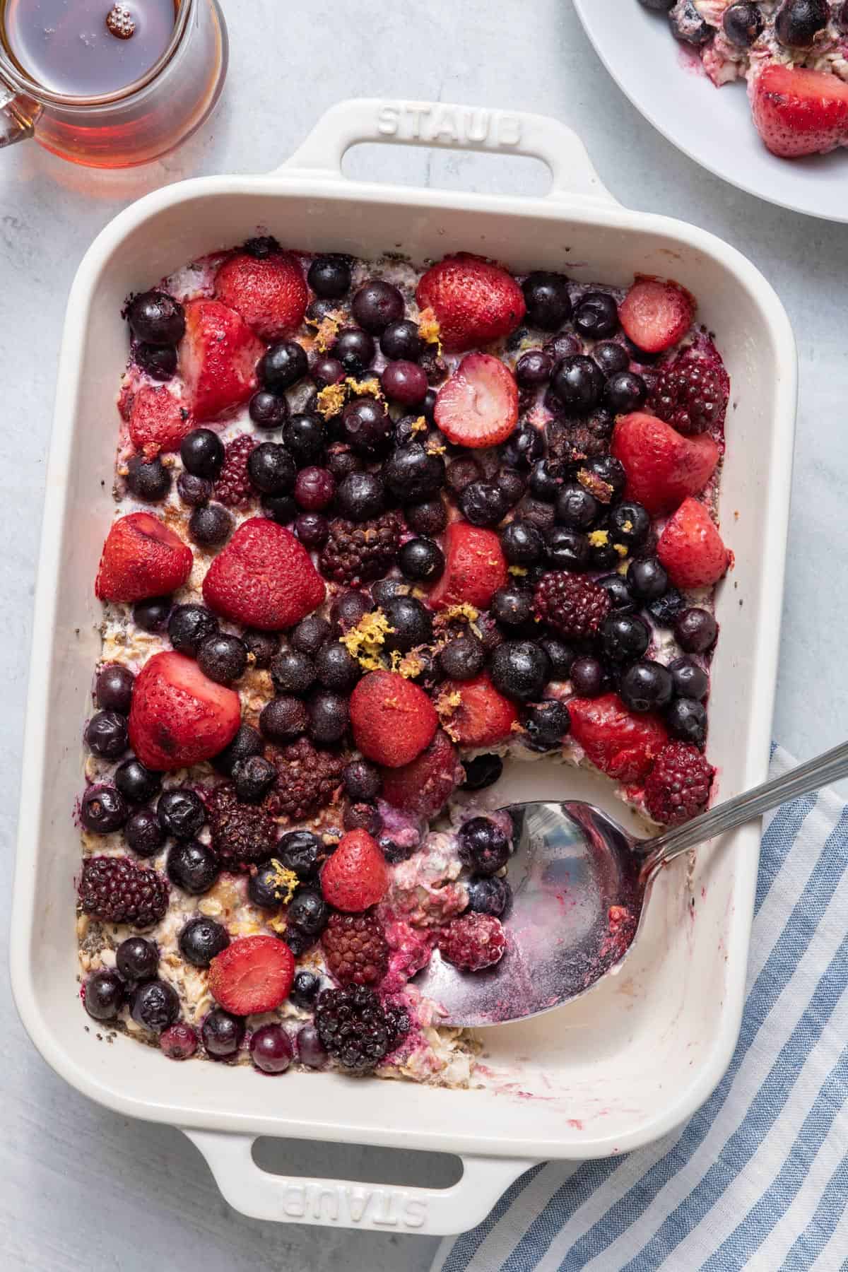 Spoon in dish of one pan baked oatmeal with portion removed.