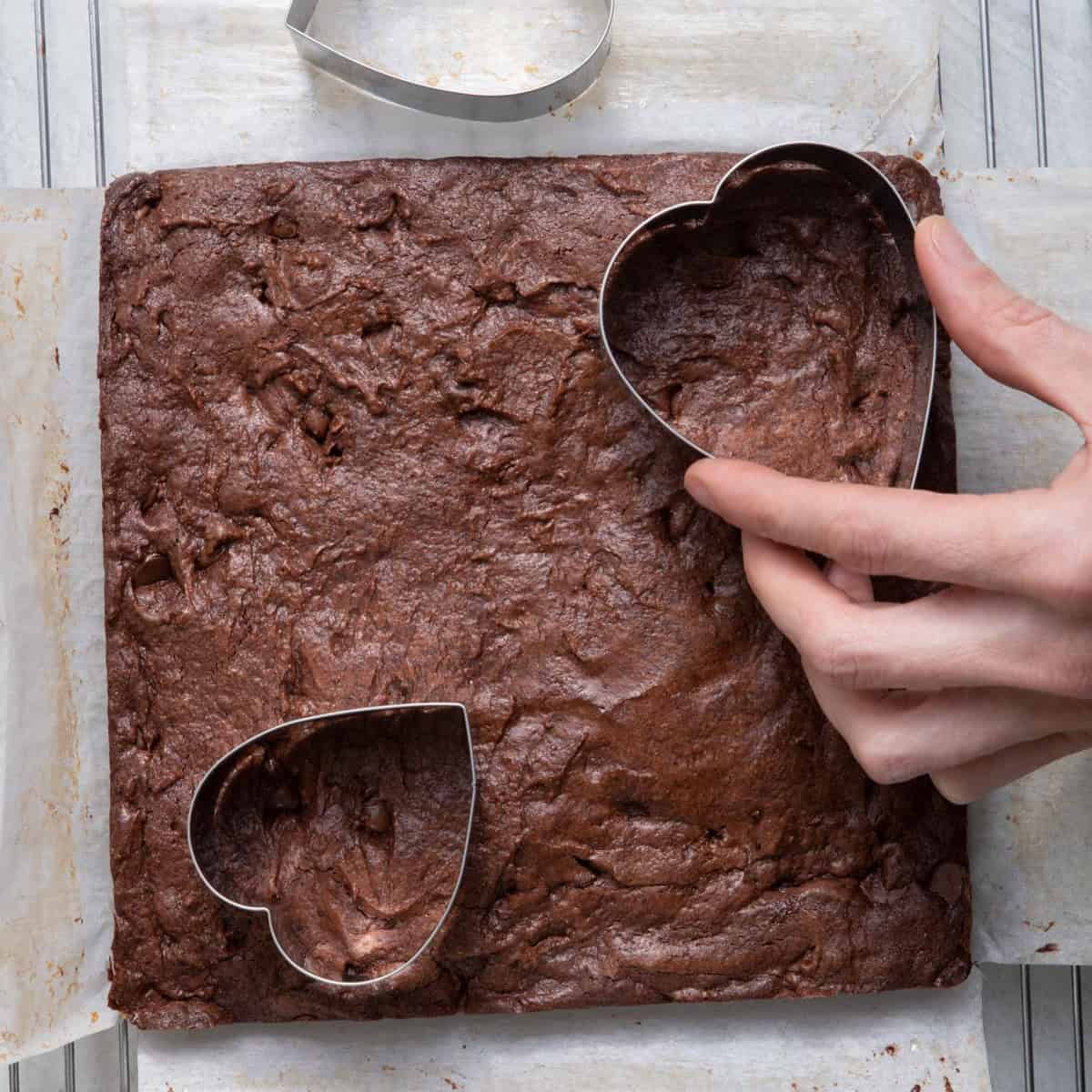 Stencil cutting up the brownies into heart shapes.