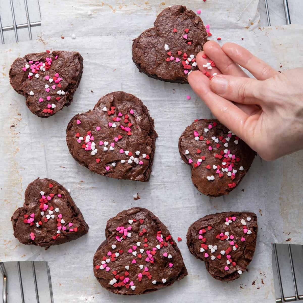 Adding sprinkles on brownies.