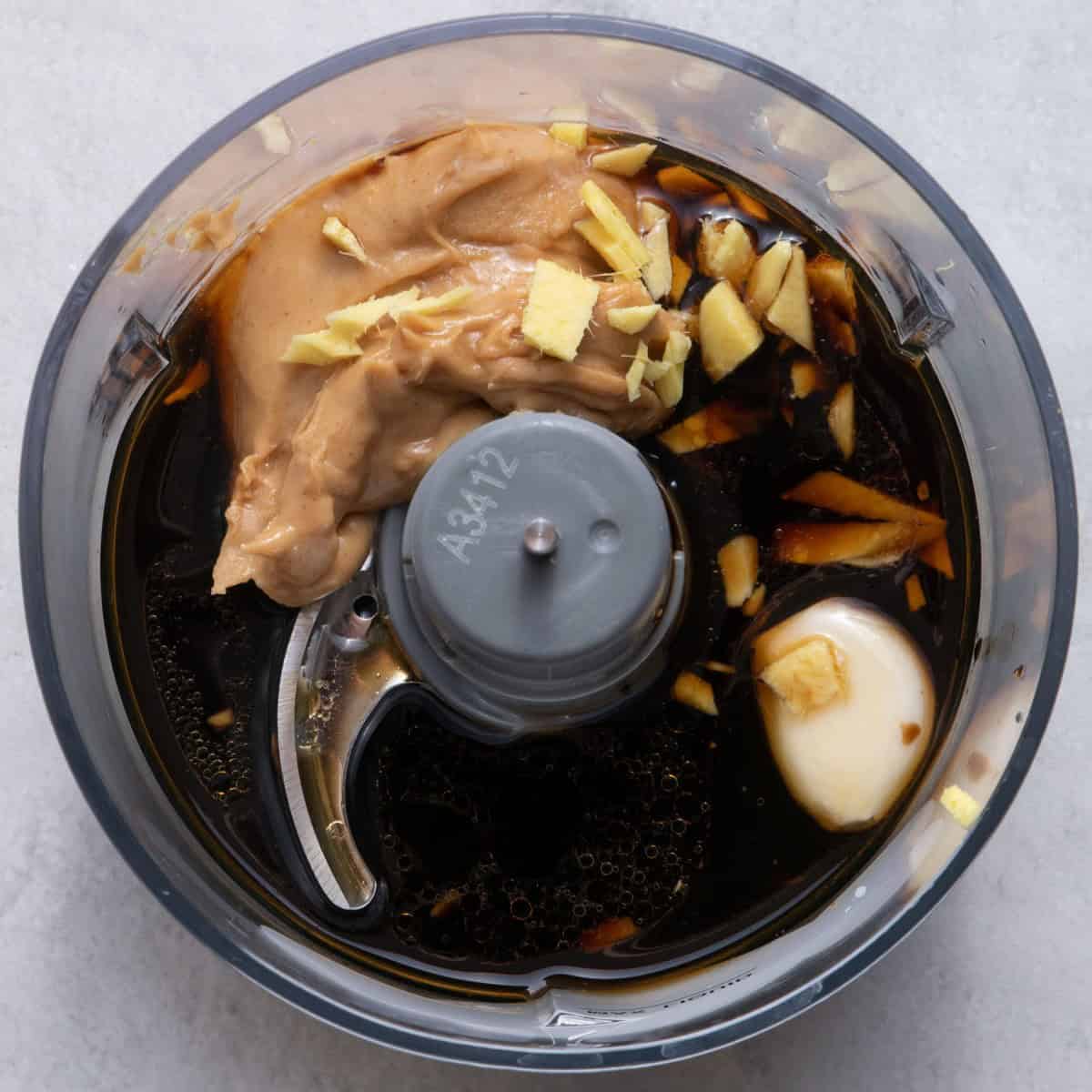Dressing ingredients in small food processor before blending.