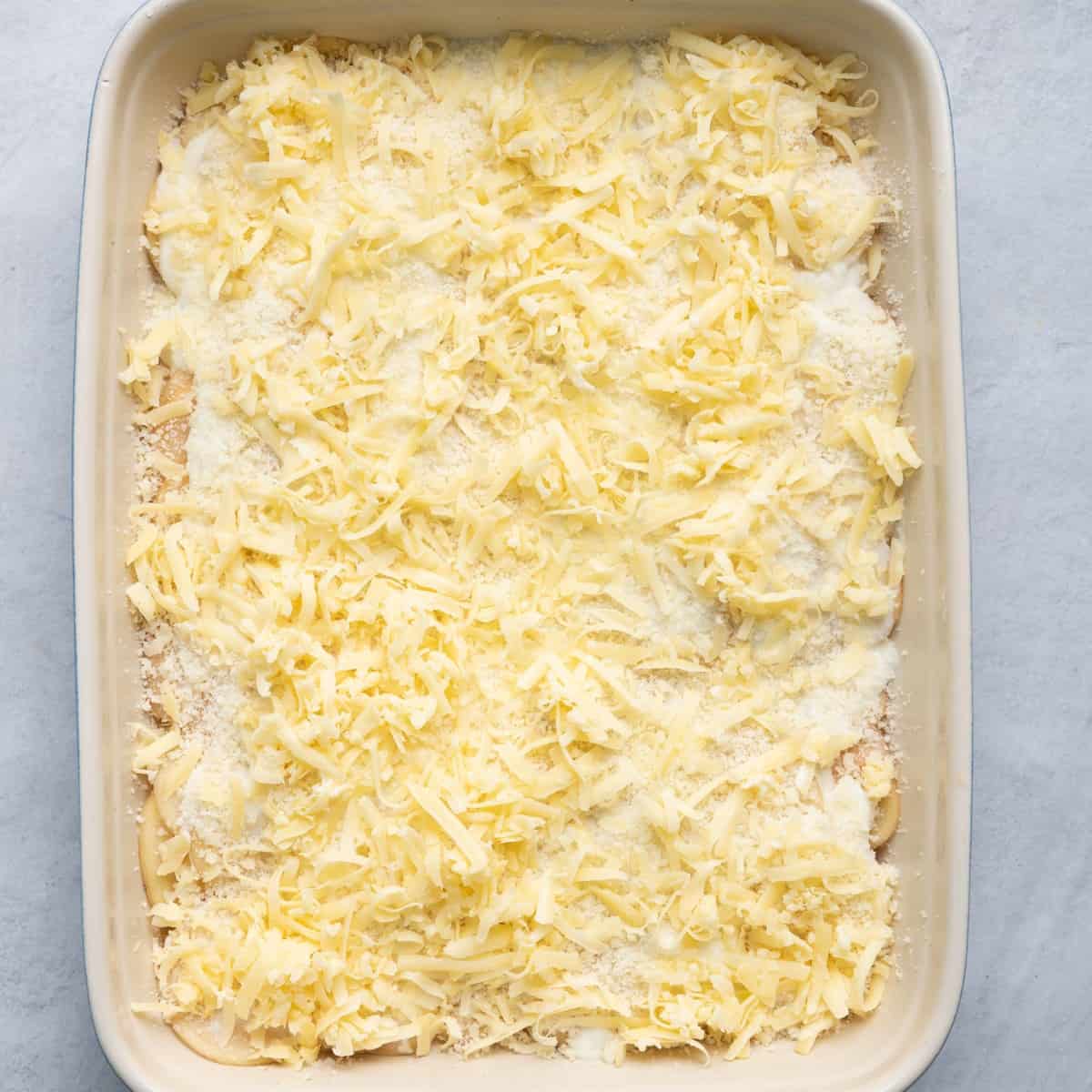 Milk and cheeses on top of potatoes.