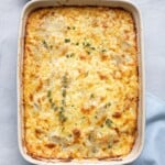 Scalloped potatoes after done baking garnished with fresh thyme leaves and black pepper.