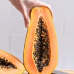 image showing inside of papaya after being cut in half lengthwise with seeds exposed