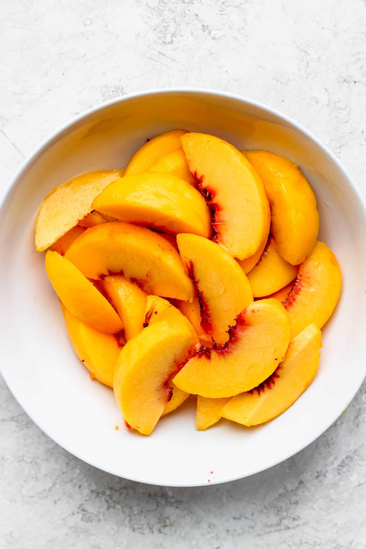 Bowl of sliced peaches