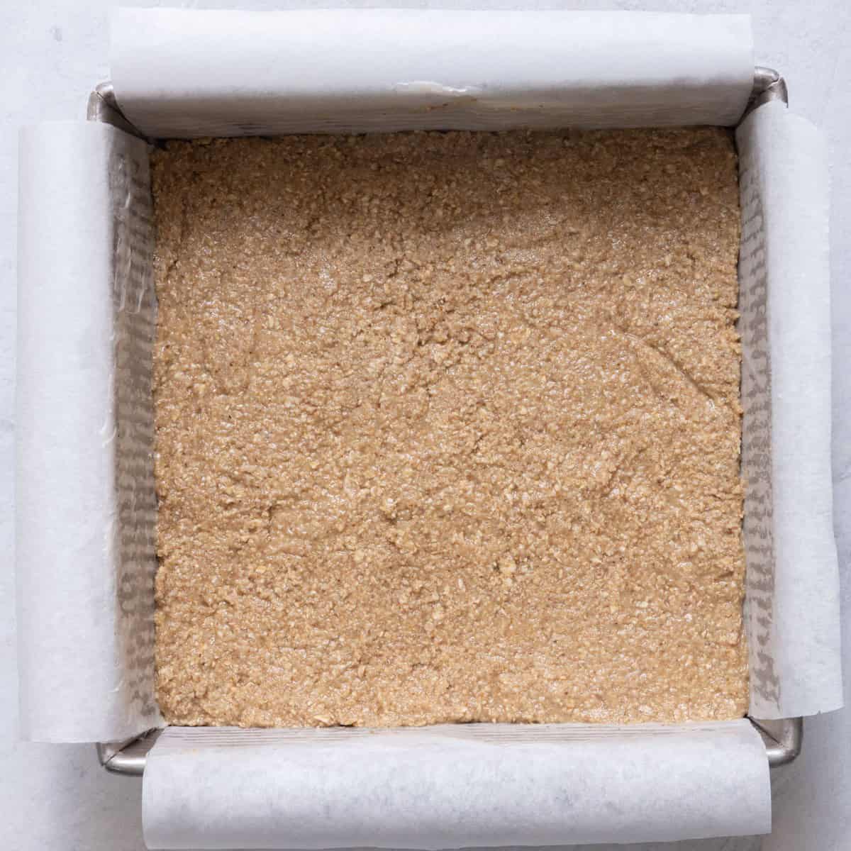 Crust mixture in baking dish before baking.