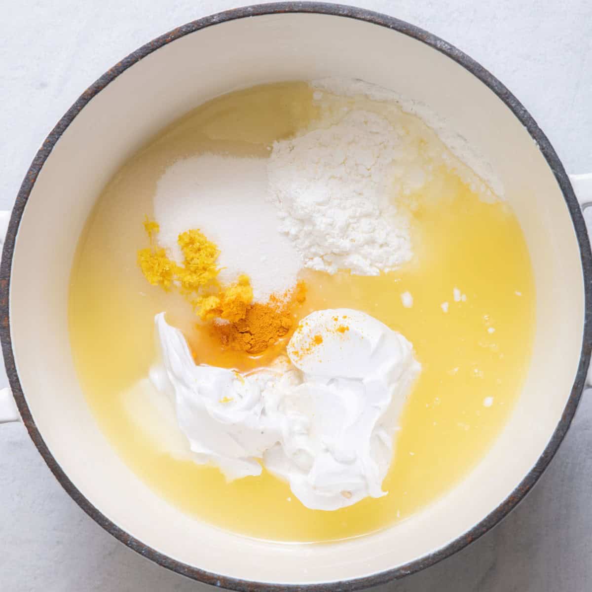 Lemon filling ingredients in a pot before whisking.