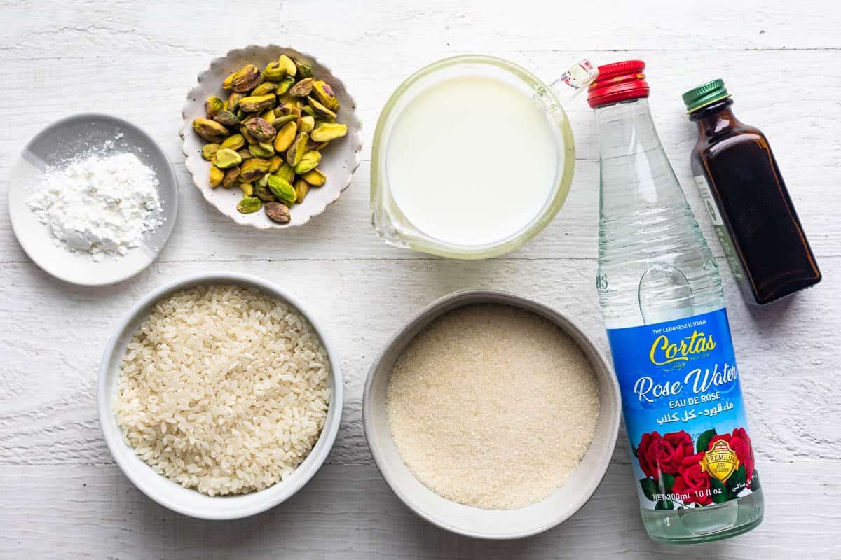 Ingredients for recipe: uncooked rice, milk, pistachios, cornstarch, sugar, rose water, and vanilla extract.