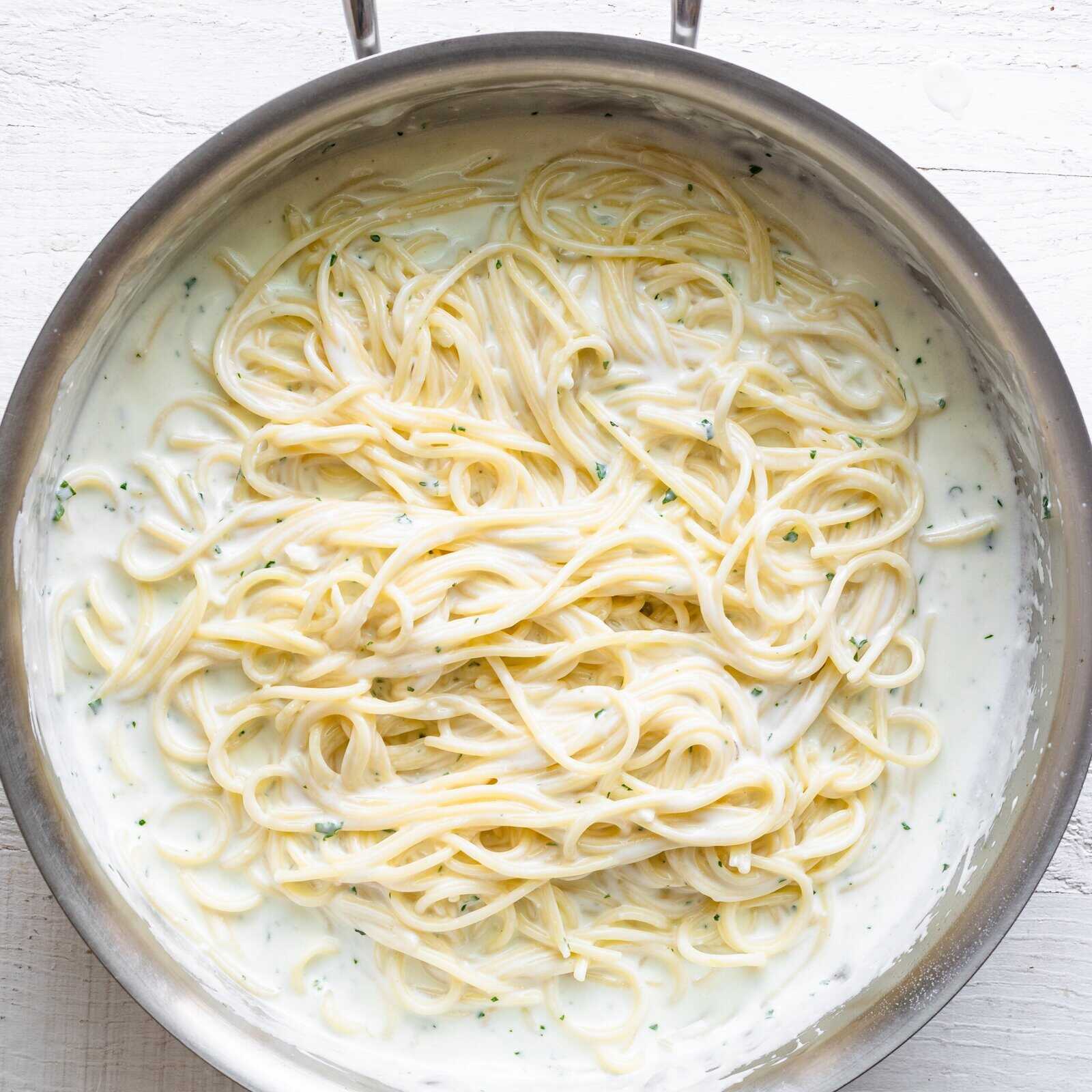 Spaghetti added to the pot of yogurt sauce and mixed thoroughly.