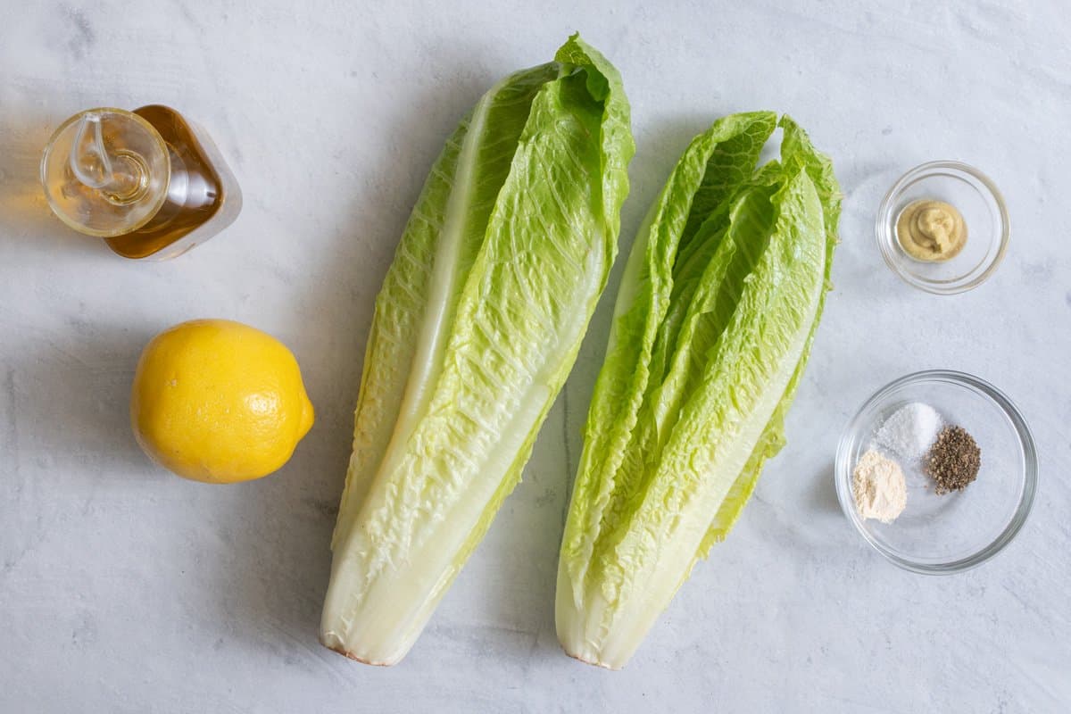 Ingredients to make the recipe: olive oil, lemon, 2 heads romaine, dijon mustard, seasonings.