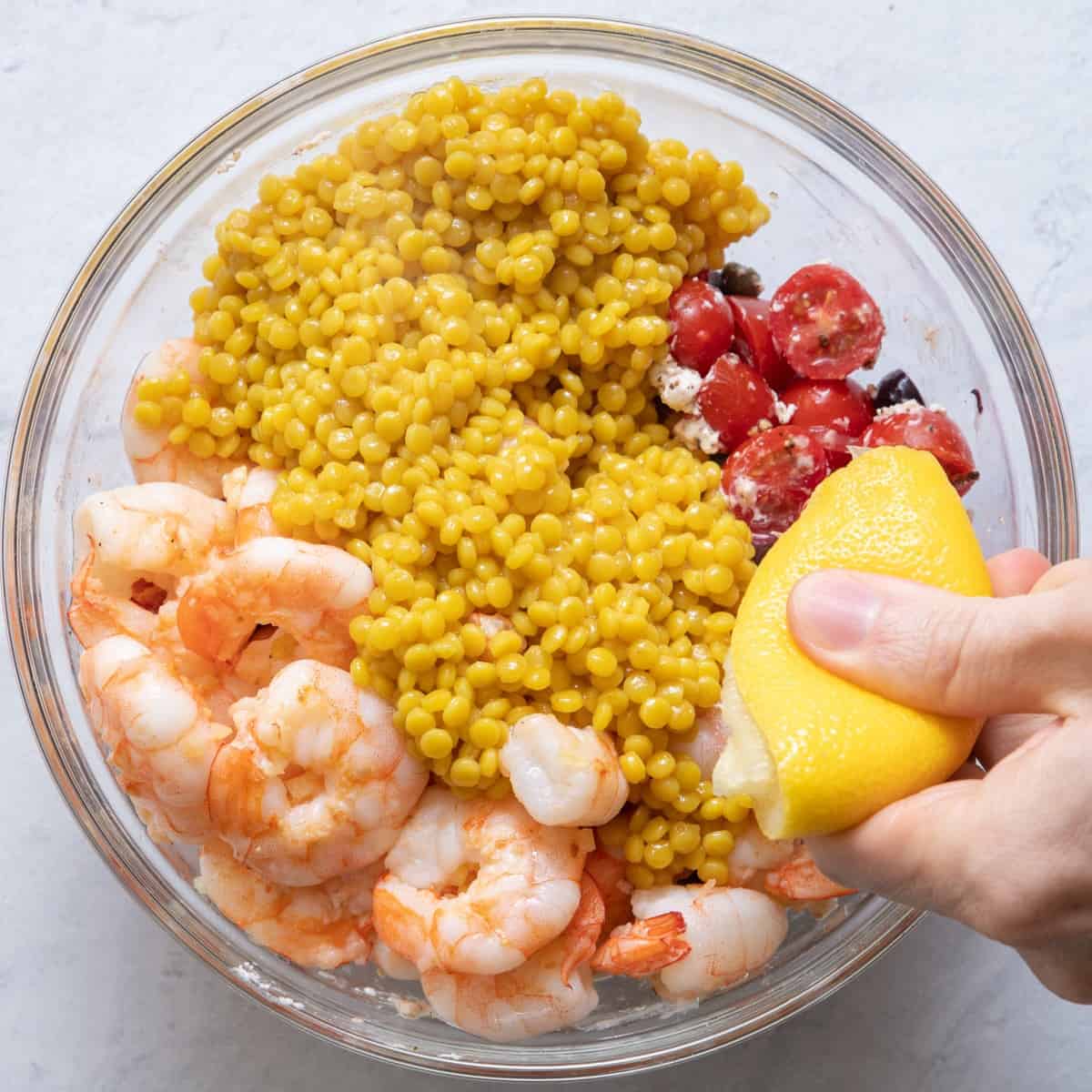Squeezing lemon juice on top.