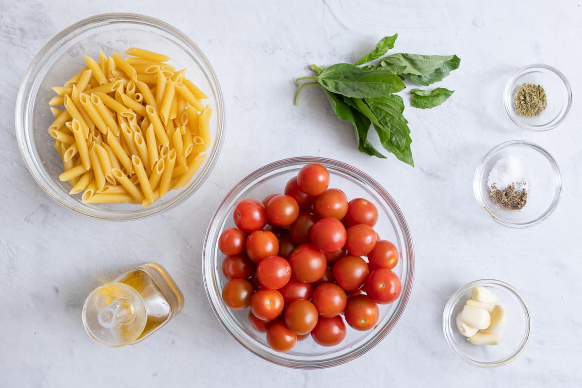 Ingredients for recipe: dry pasta, oil, cherry tomatoes, fresh basil, and spices.