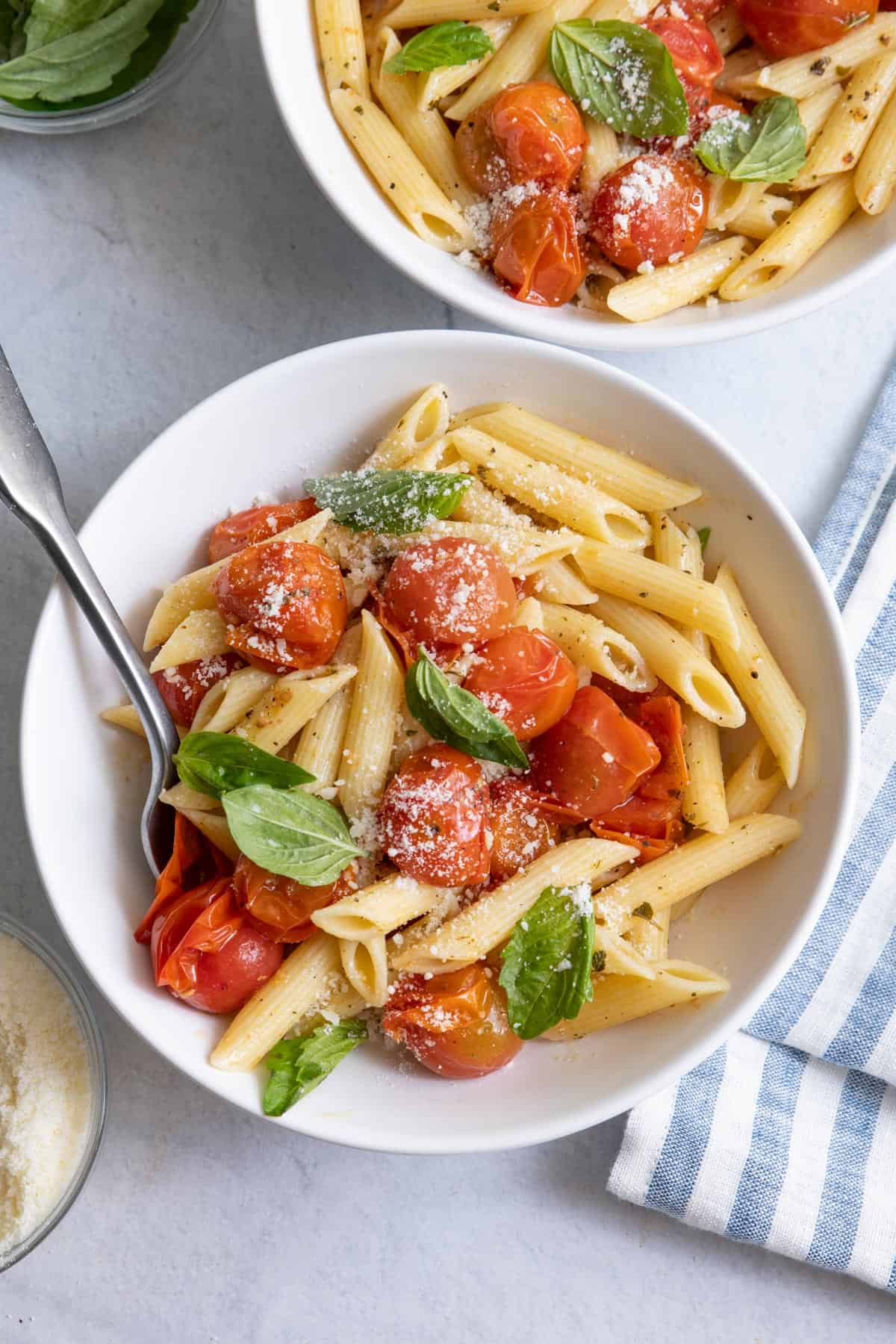Overhead shot of two bowls of Roasted tomato pasta.