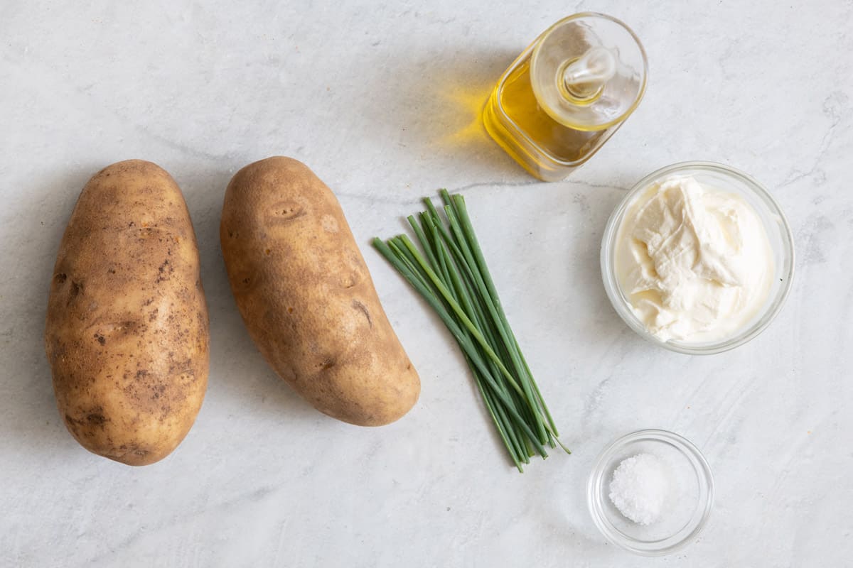 Ingredients for recipe: 2 potatoes, chives, oil, butter, and salt.