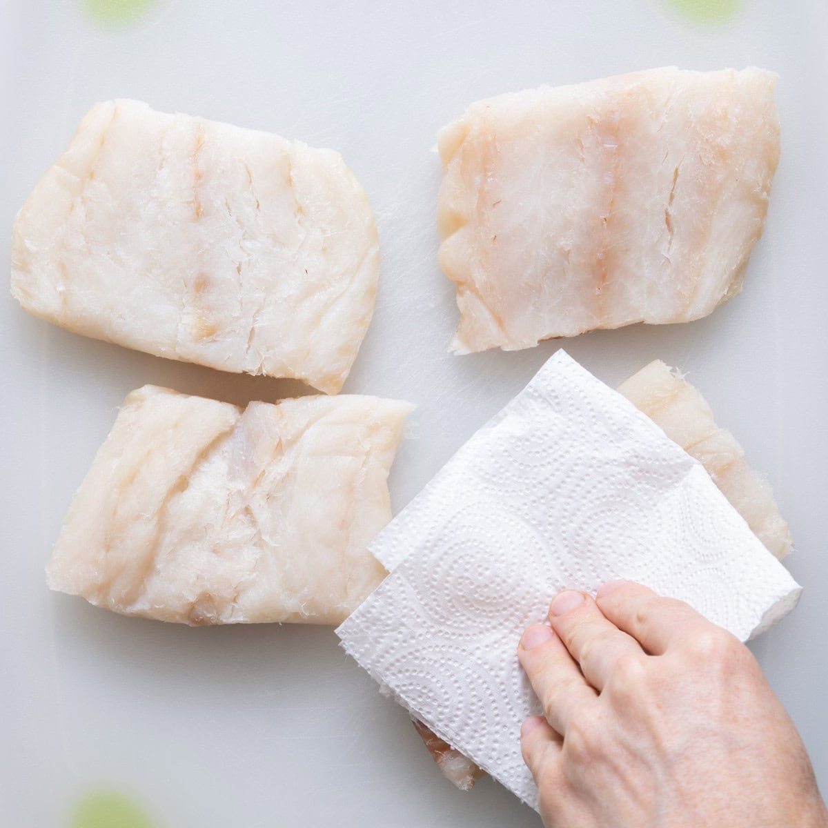 Wiping cod with paper towel.