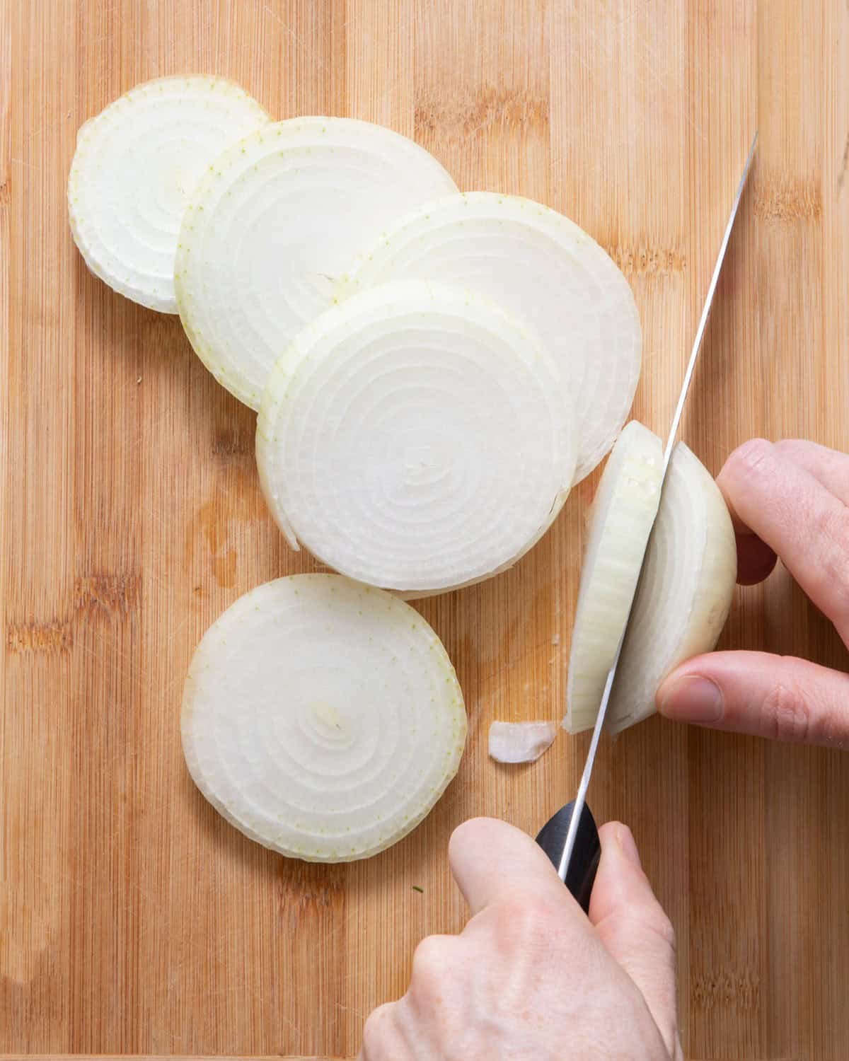Slicing of onion to show last ring getting sliced.