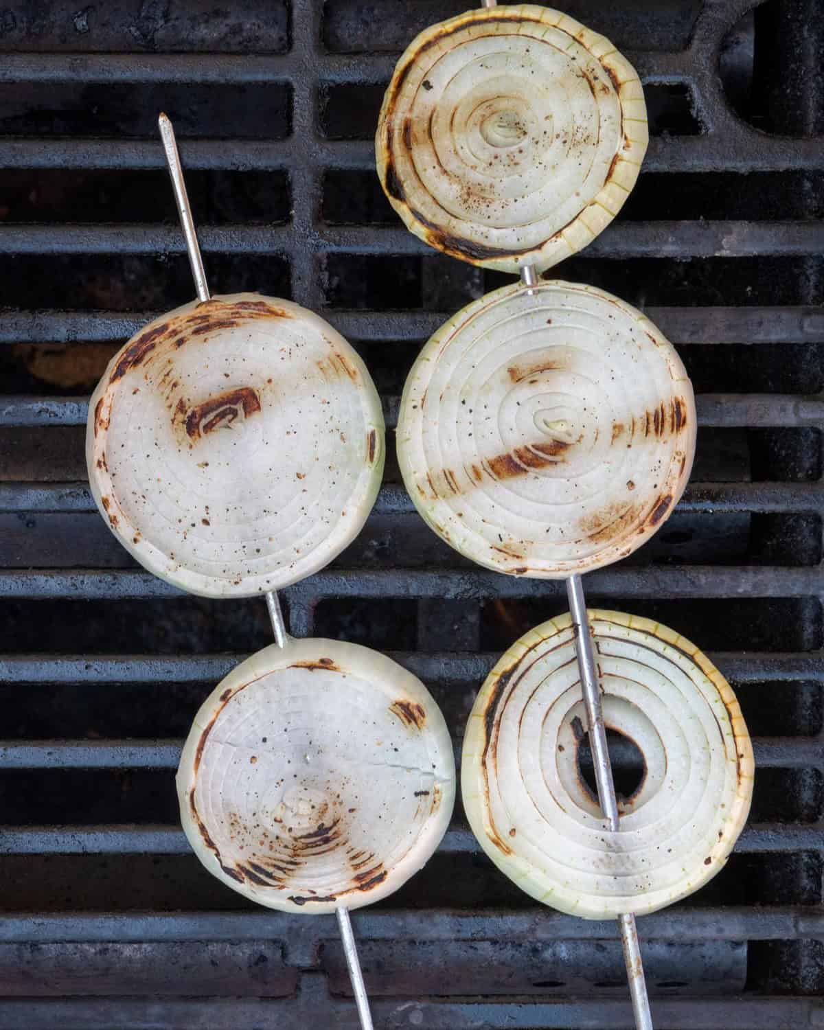 Onion slices on grill after grilling.