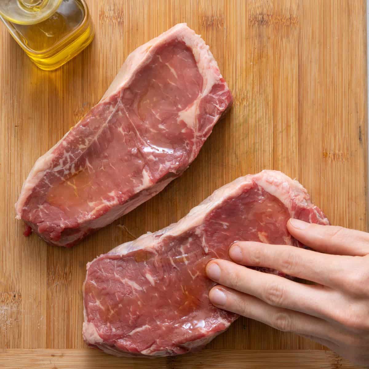Rub steaks with olive oil.