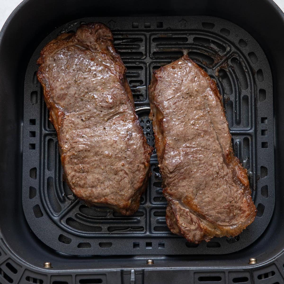 2 steaks in air fryer after cooked.