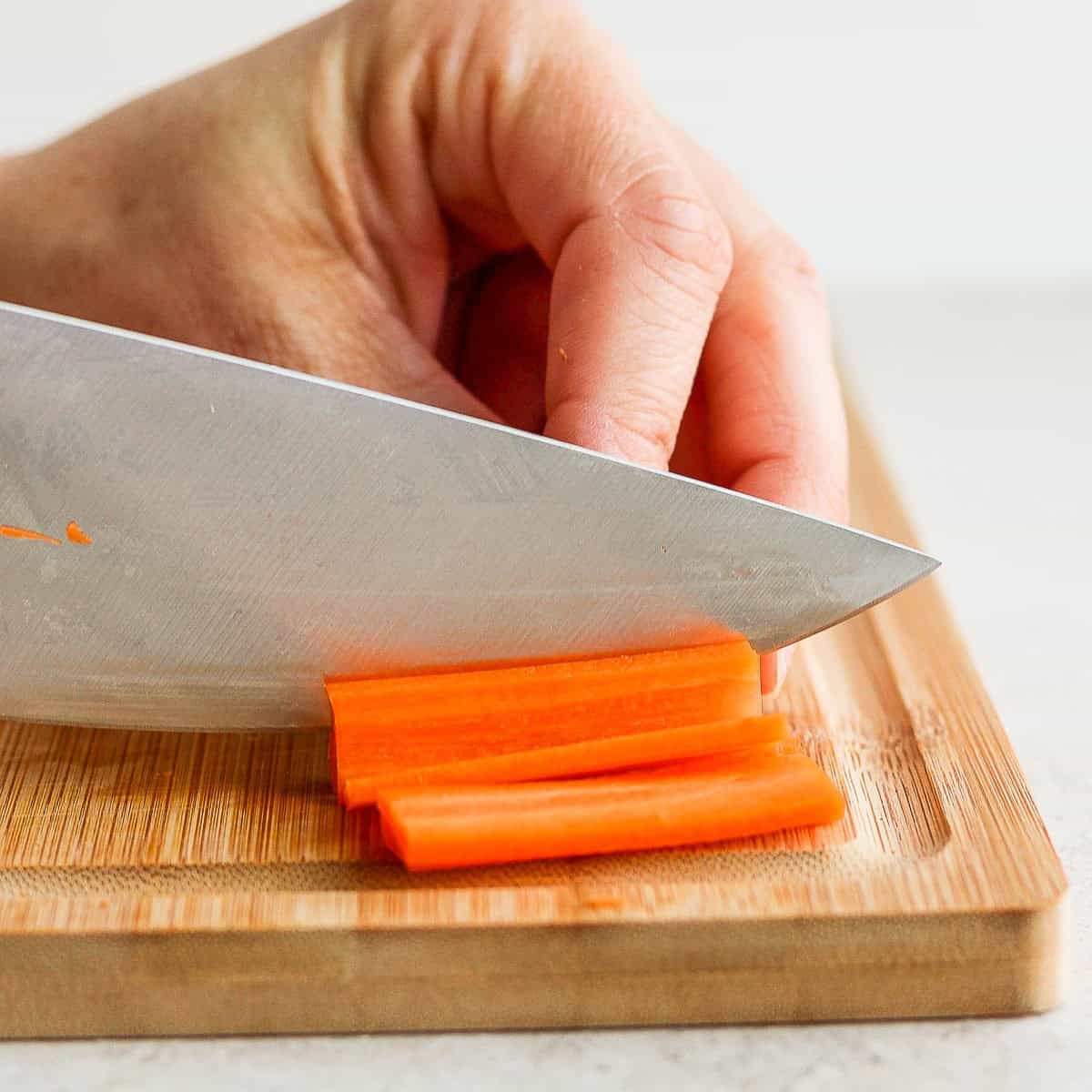 Cutting โ
inch slabs of carrots.