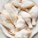 All the pieces together on a wide plate to show the different parts of the chicken.