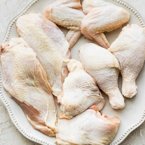 All the pieces together on a wide plate to show the different parts of the chicken.