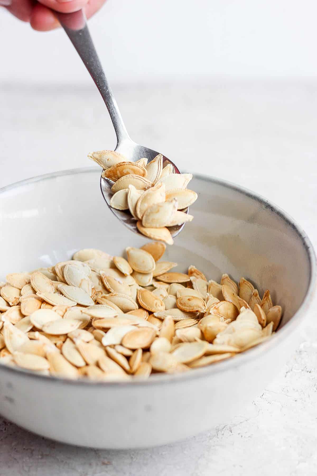 Spoon scooping up some from a bowl.