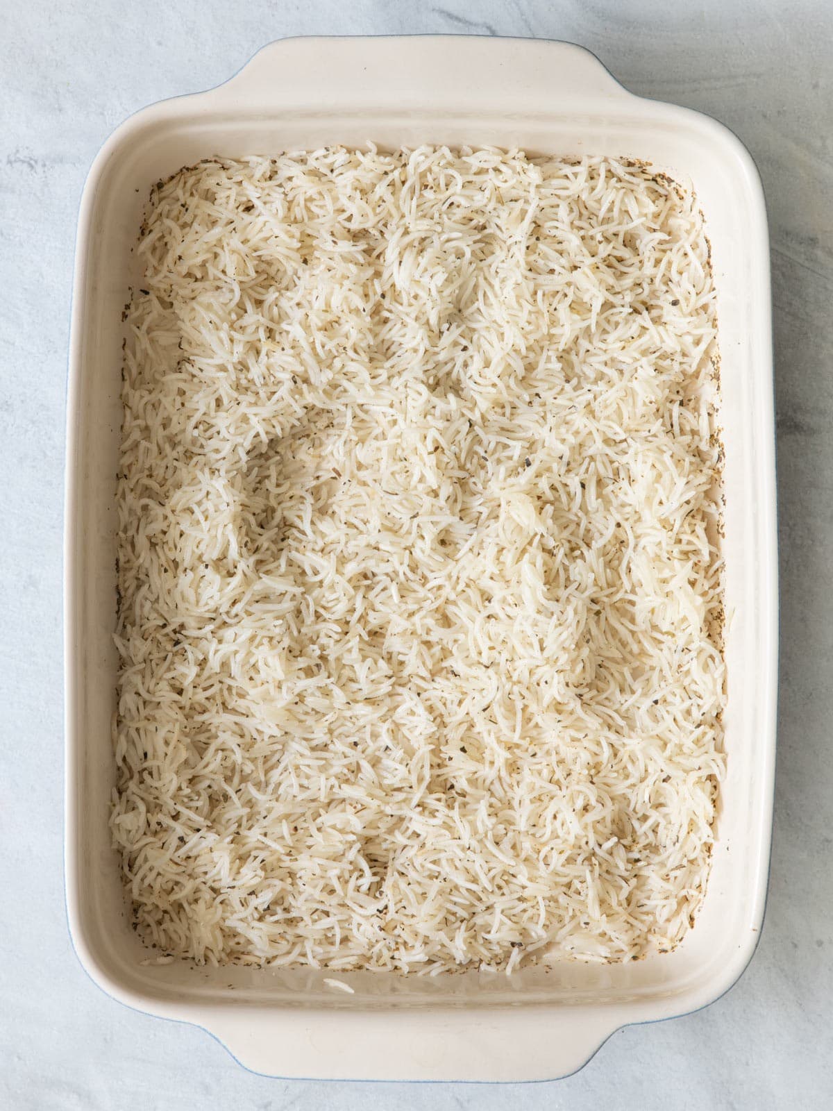 Cooked rice alone in the baking dish.