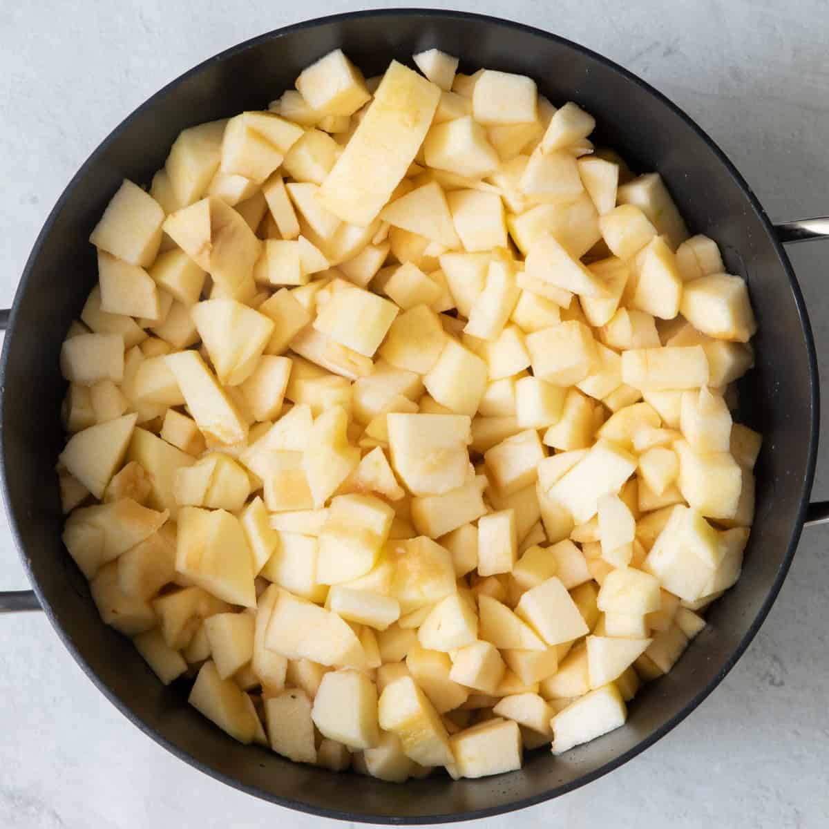 Apples and apple cider in pot.