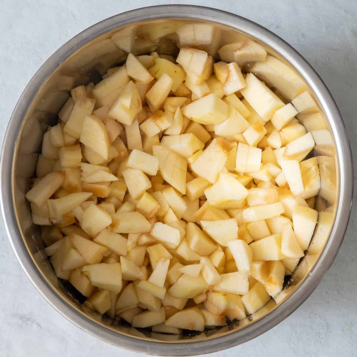 Apples and apple cider in pot.