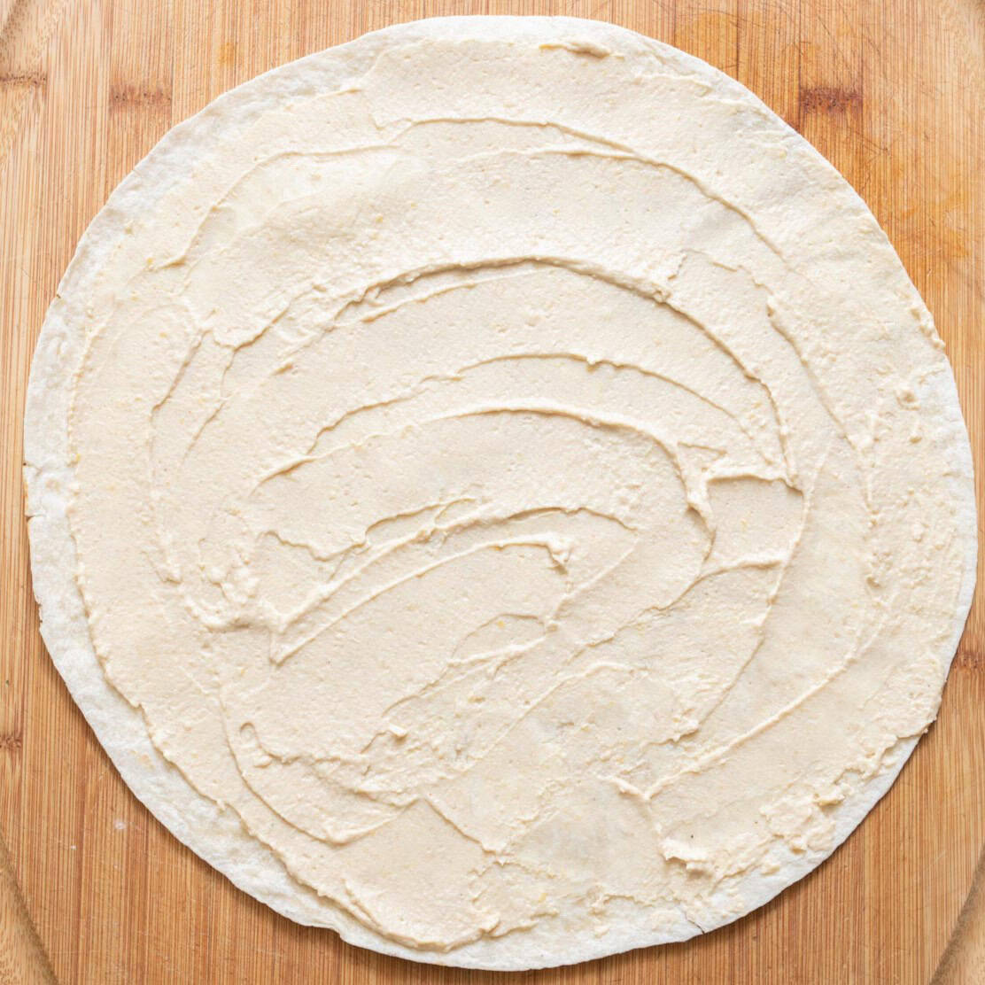 Tortilla with first ingredient.