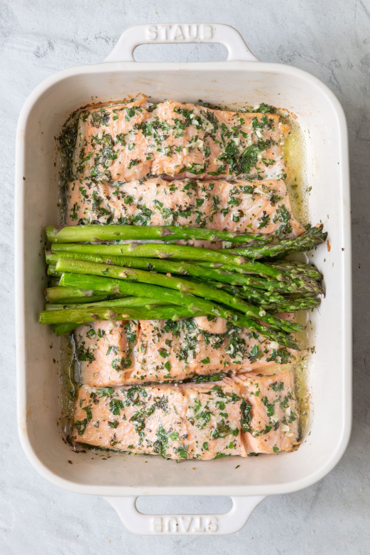 Salmon and asparagus in the baking dish after cooking.