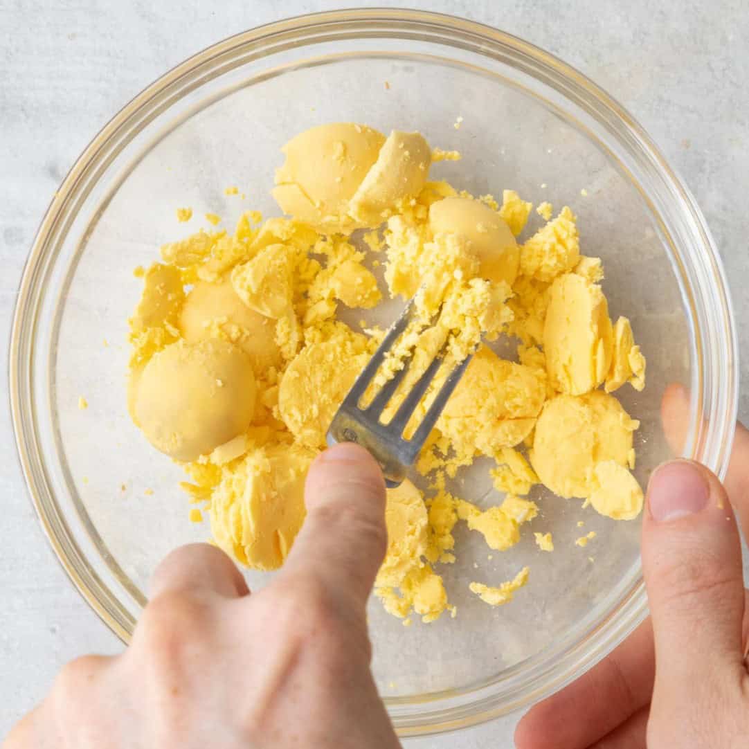 Mash egg yolks with fork.