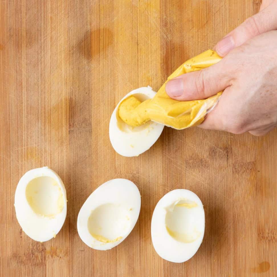 Piping turmeric eggs.