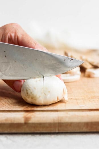 Cutting a mushroom into quarters.