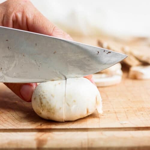 Cutting a mushroom into quarters.