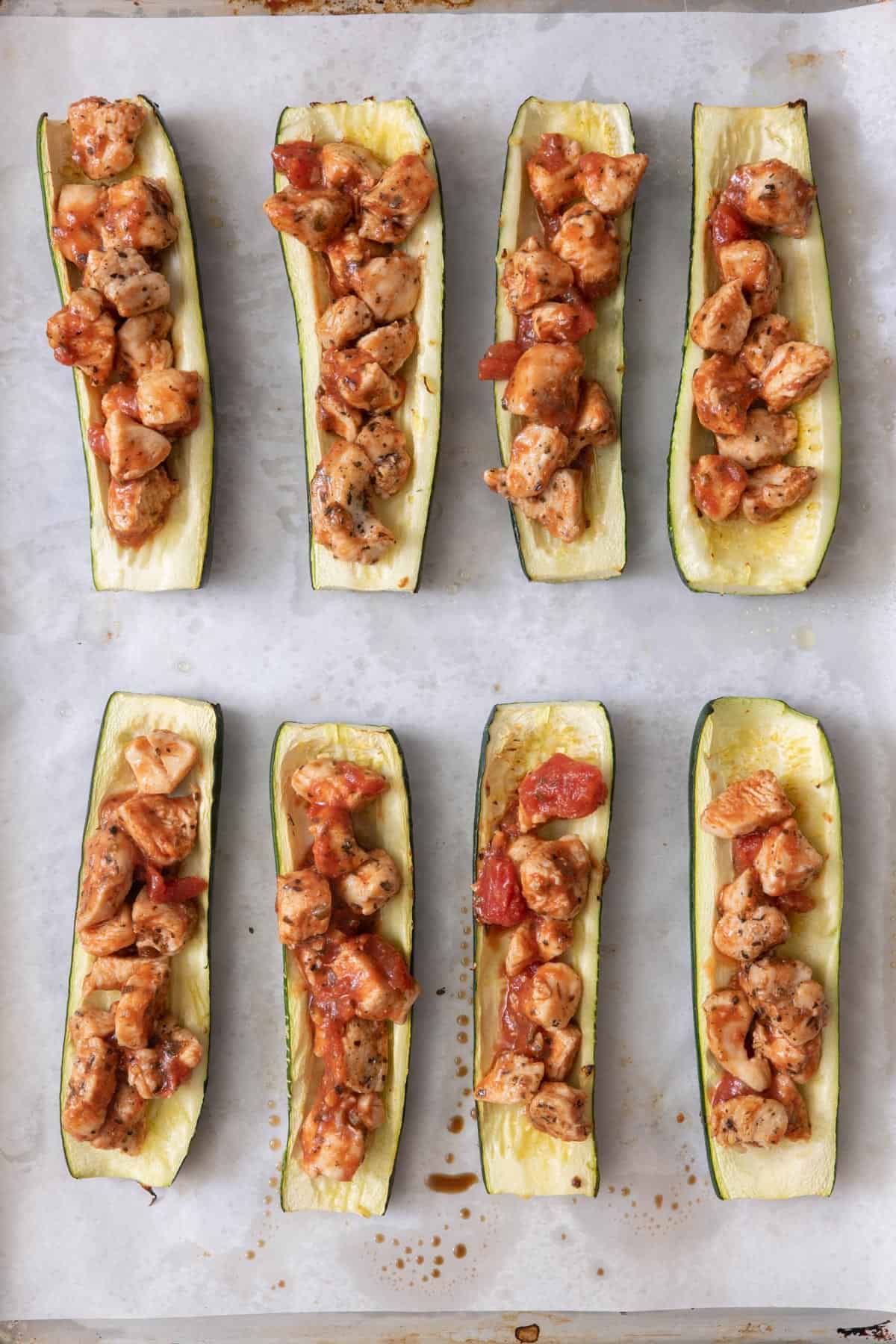 Chicken mixture added to zucchini boats.