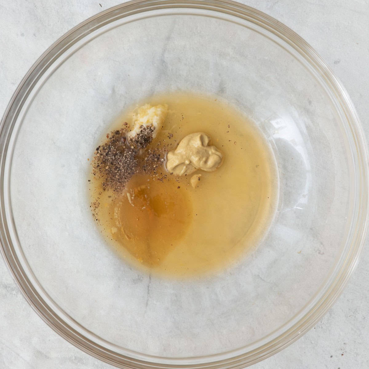 Dressing ingredients in serving bowl before being mixed.