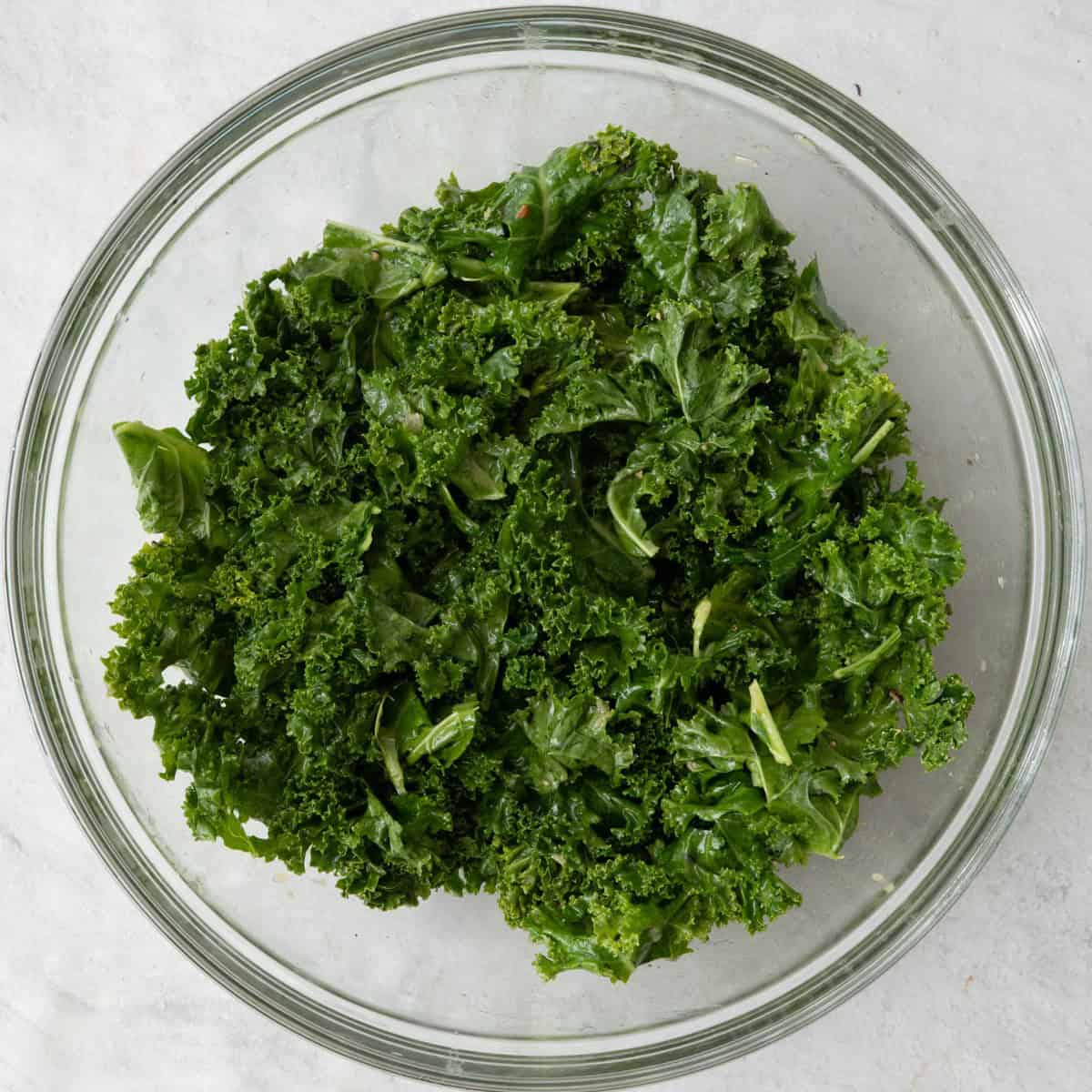 Kale after dressing massaged in showing bright green pieces.