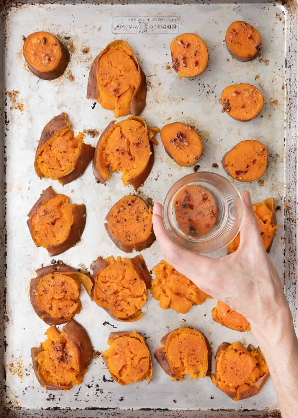 Small cup smashing potato rounds with some smashed and a few not smashed.