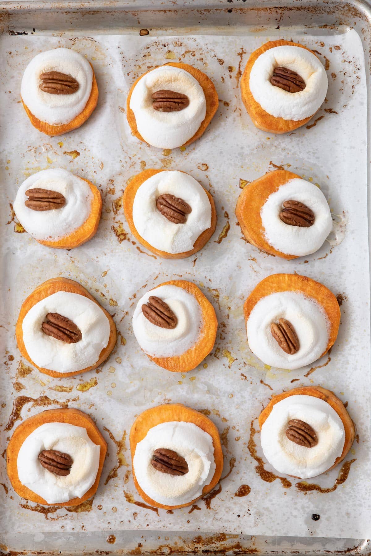 Sweet potatoes with melted marshmallow and pecan.
