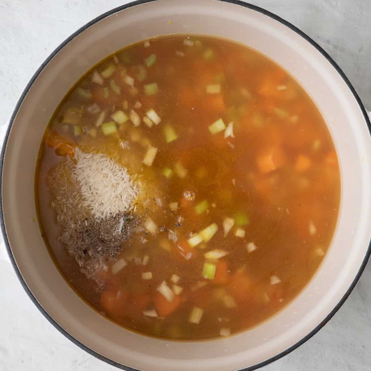 Added rice, rosemary, salt, pepper, and chicken stock.
