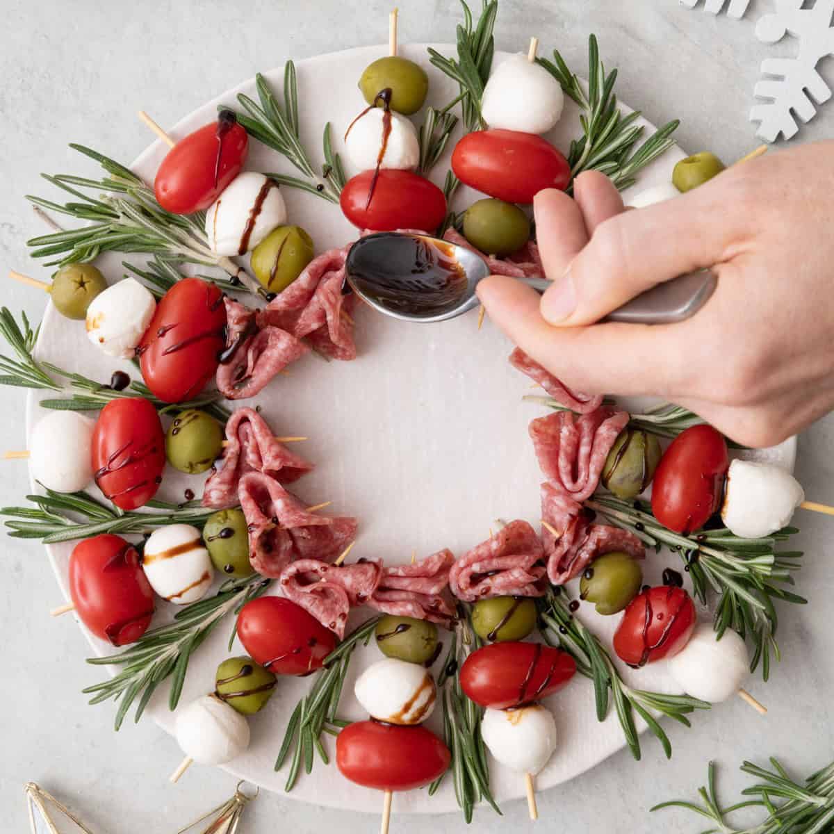 Drizzling balsamic vinegar on top.
