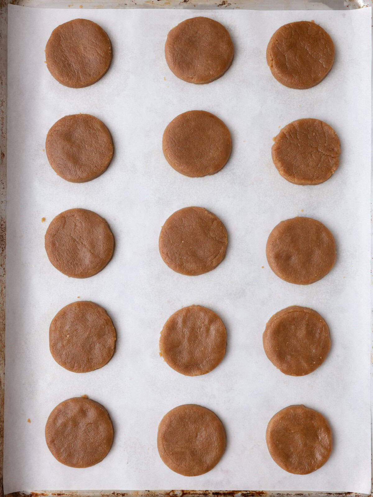 15 cookies on baking tray before baked.