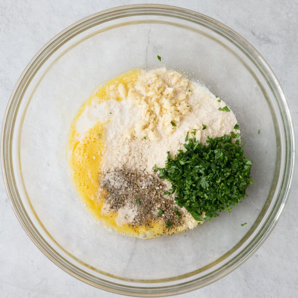 Bowl with panko, egg, milk, parsley, garlic, and seasonings.