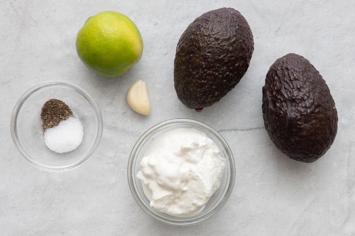 Ingredients for recipe: salt and pepper, lime, garlic clove, and greek yogurt.